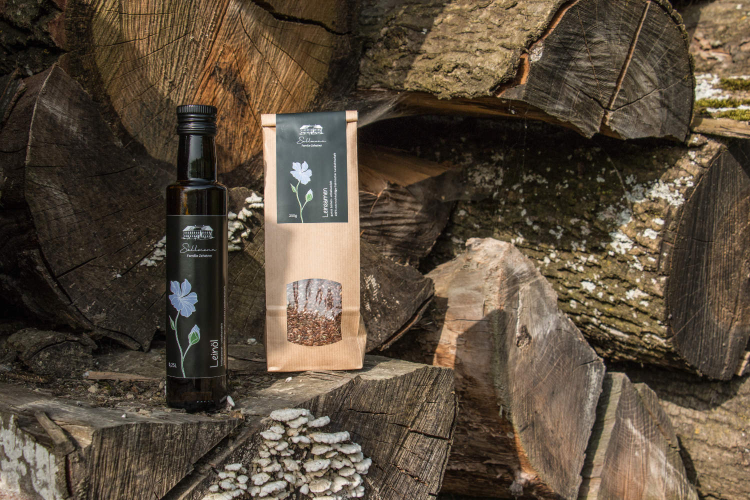 Leinöl und Leinsamen stehen auf dem Holzstapel.